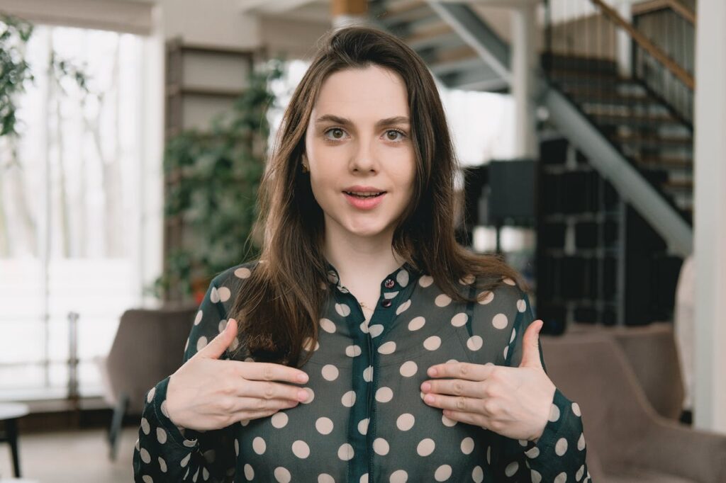 Young woman filming video in light apartment